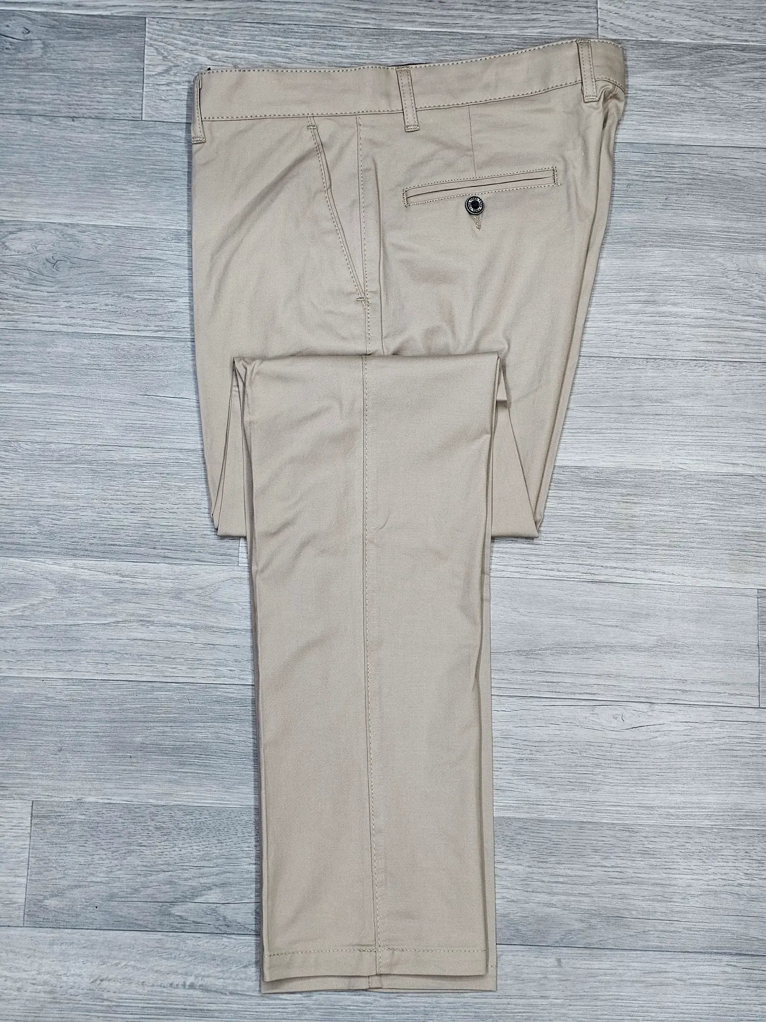 Beige pants on a gray wooden floor