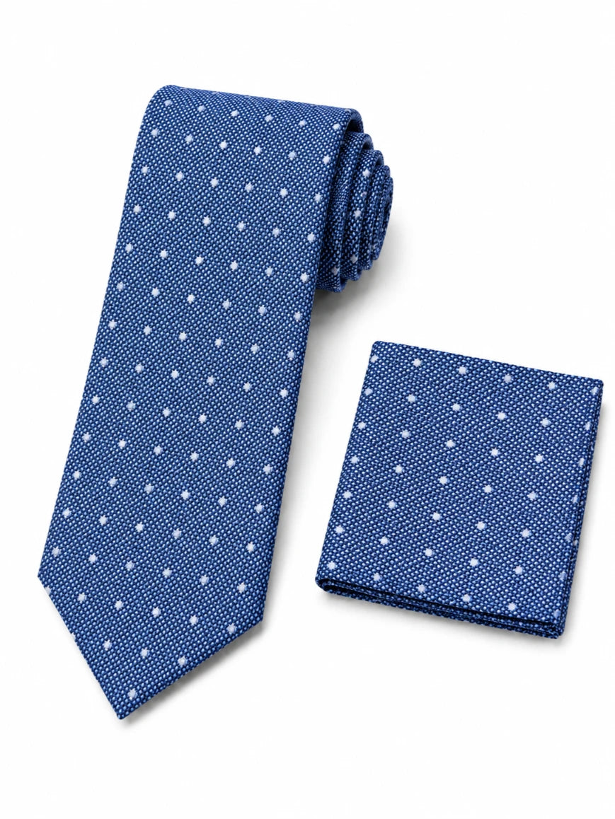 Infynite cobalt blue micro dot tie and pocket square set with white dots on woven textured base laid flat on white background