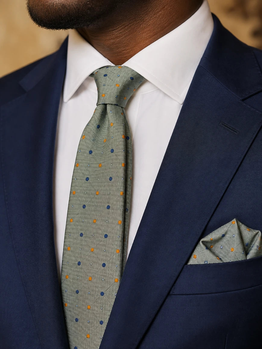 Infynite sage green dual-colour polka dot tie and pocket square set styled with a navy suit and white dress shirt