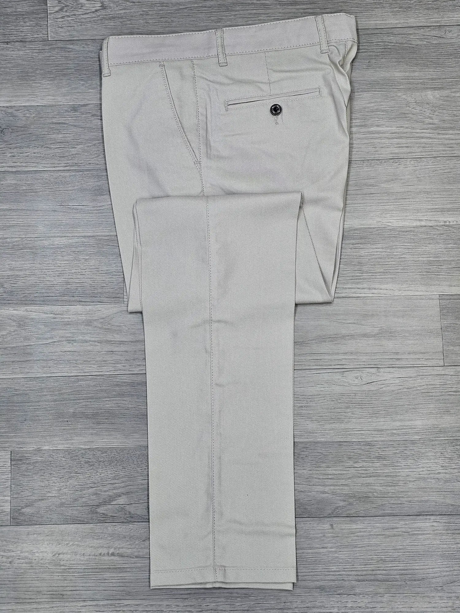 Cream regular fit chino pants on a wooden floor