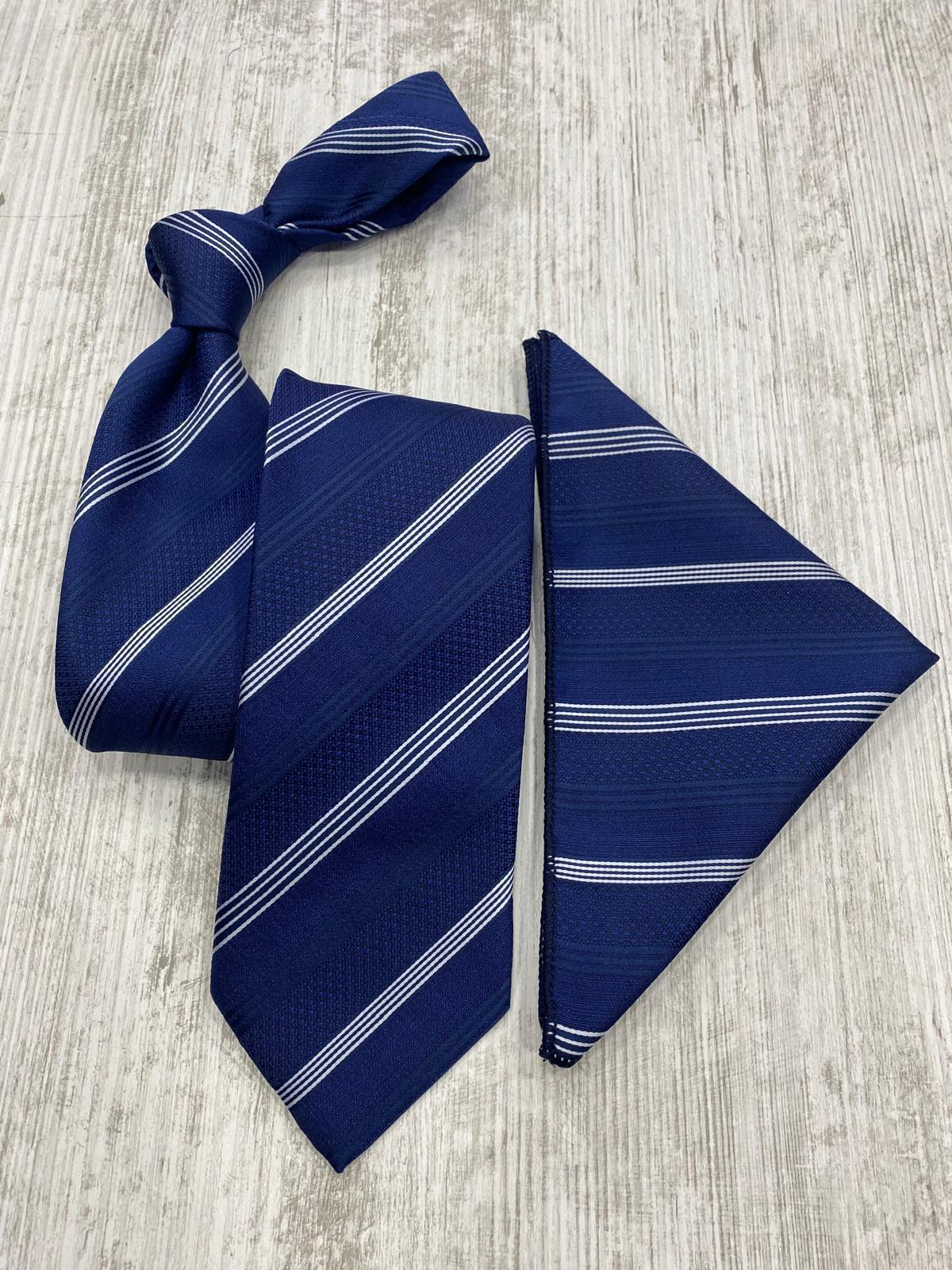 Navy blue tie with white stripes and matching pocket square on a light wooden surface