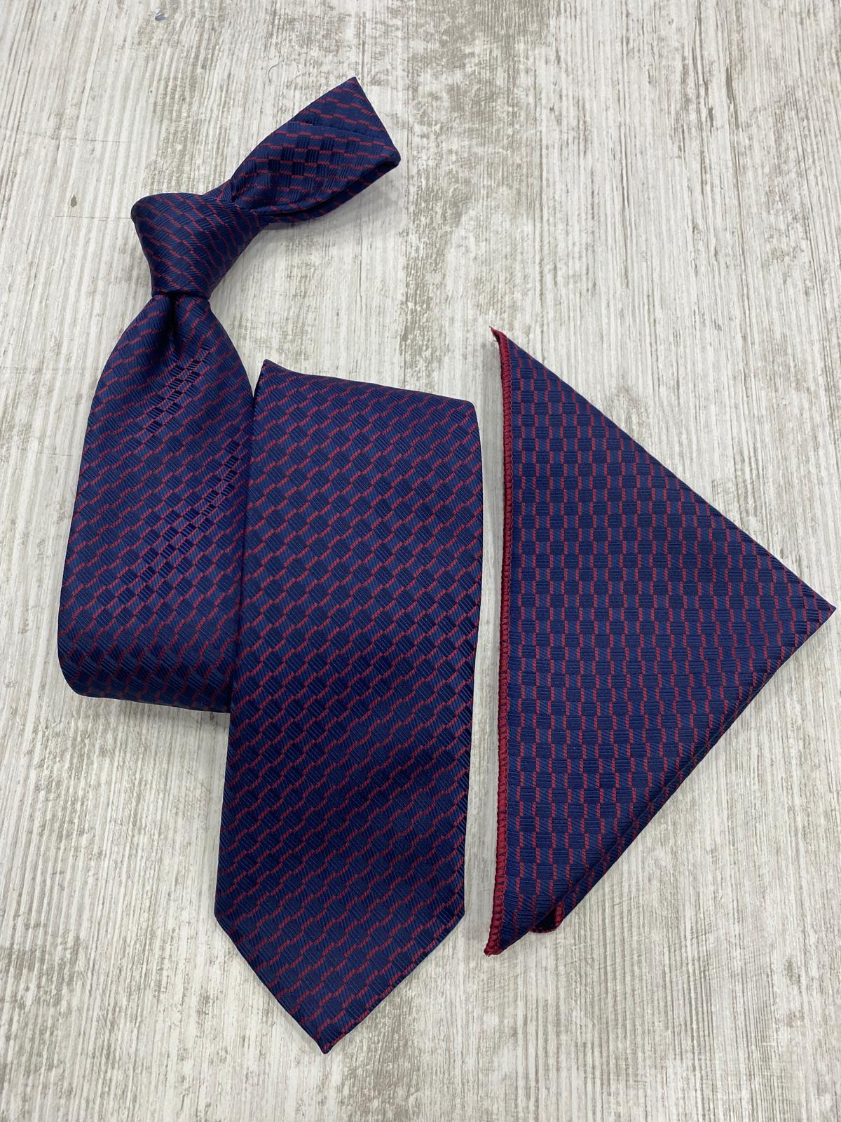 Navy blue tie and pocket square set on a light wooden surface