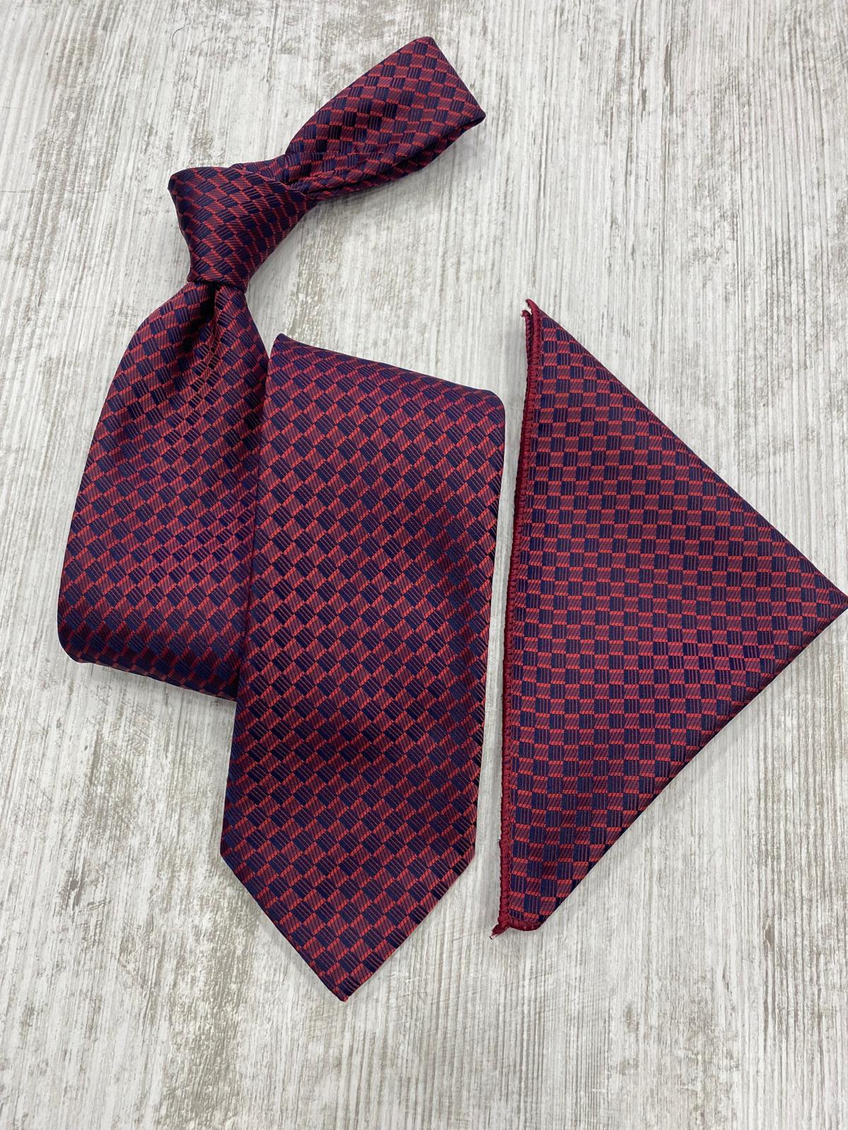 Maroon patterned tie and pocket square on a light wooden surface