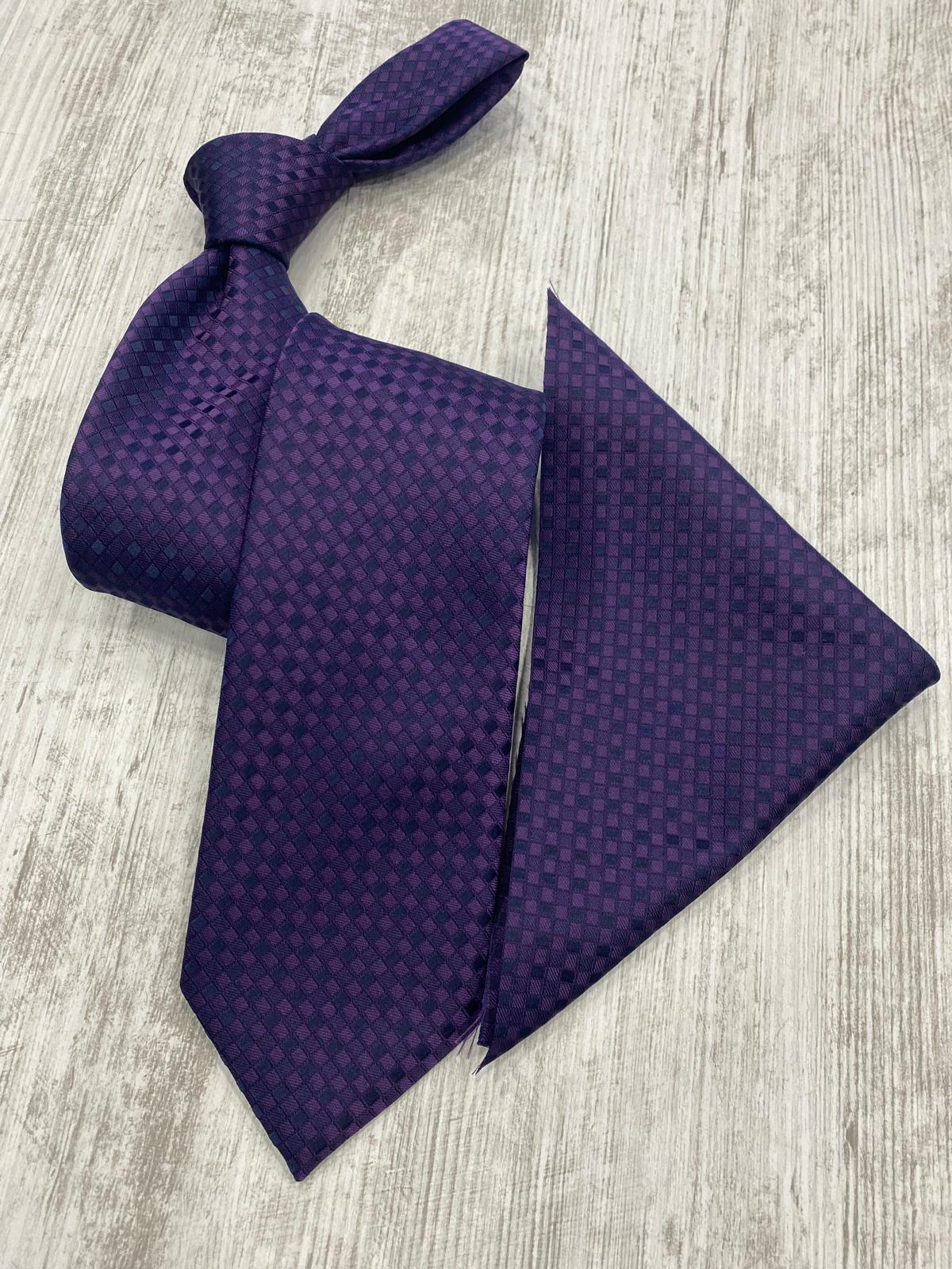 Purple patterned tie and pocket square on a light wooden surface