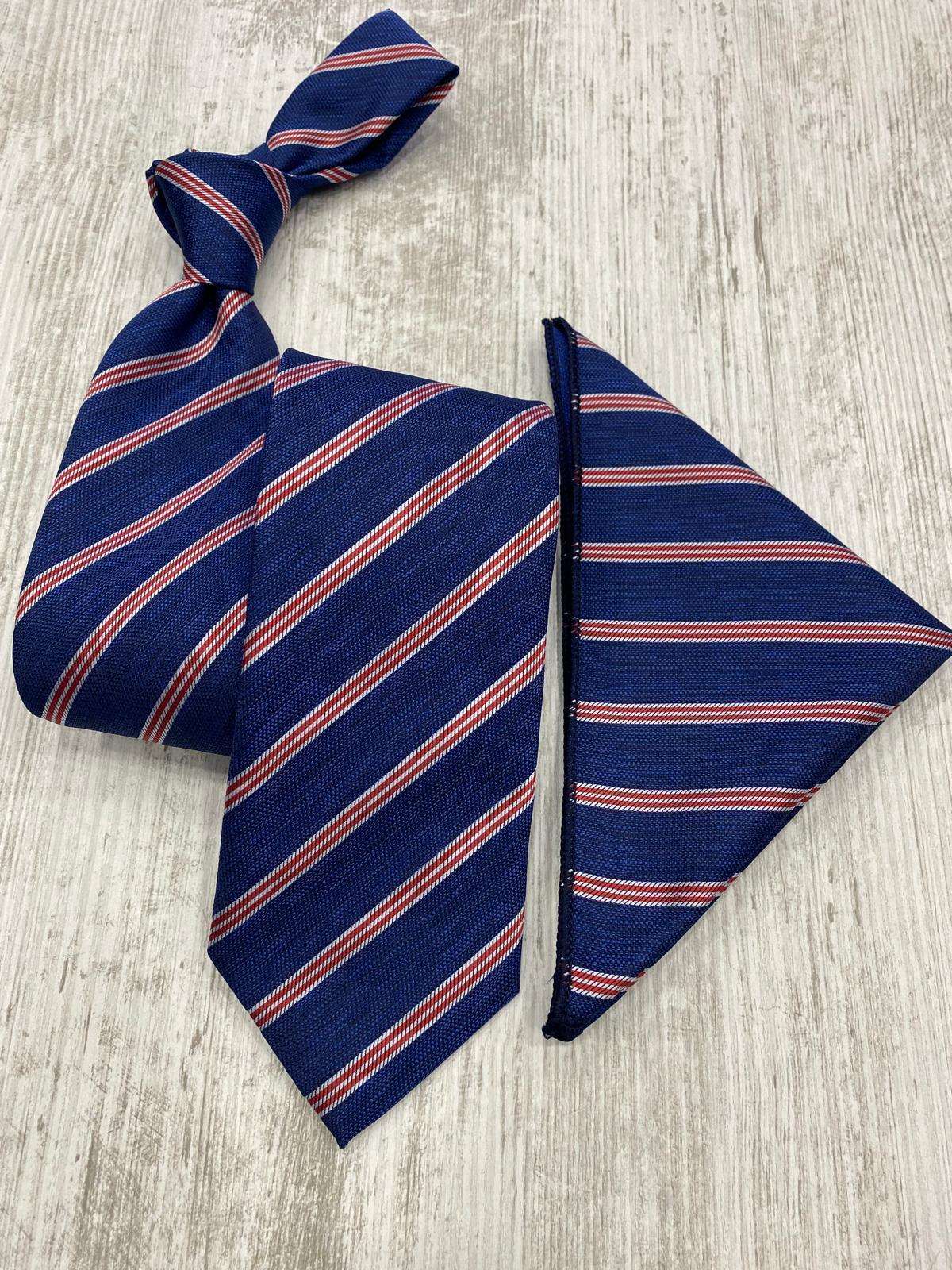 Navy blue tie with red stripes and matching pocket square on a light wooden surface