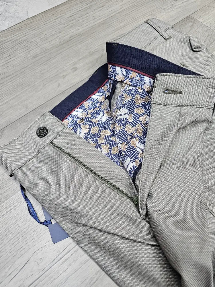 Gray pants with a patterned lining on a wooden floor