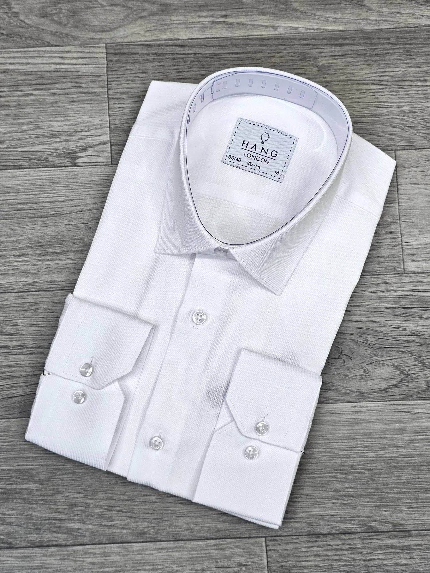 White dress shirt with collar on a wooden surface
