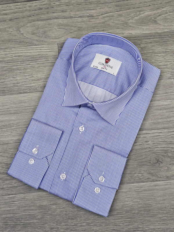 Folded blue and white striped dress shirt on a wooden surface
