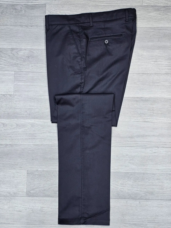 Black regular fitting chino pants on a gray wooden floor