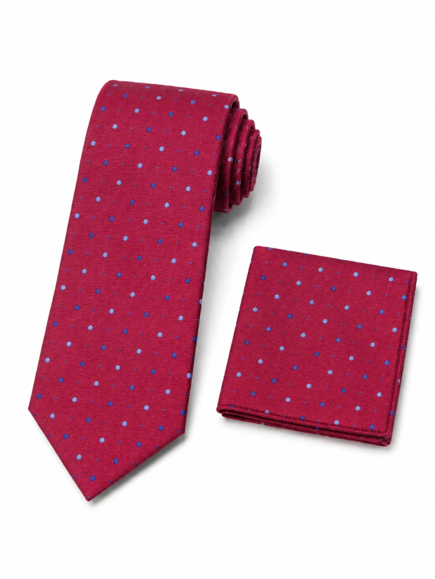 Infynite crimson red dual polka dot tie and pocket square set with blue and light blue dots laid flat on white background
