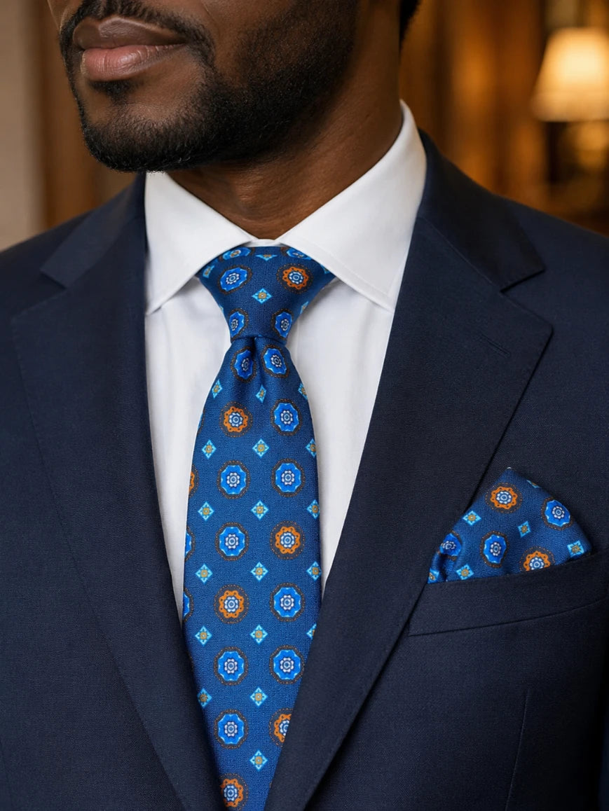 Infynite royal blue floral medallion tie and pocket square set styled with a navy suit and white dress shirt