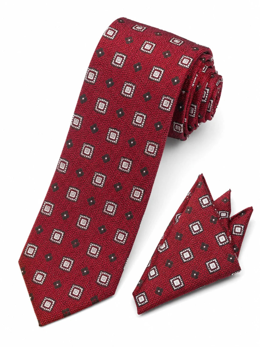 Infynite crimson red geometric square medallion tie and pocket square set with white-bordered squares and dark dot accents laid flat on white background