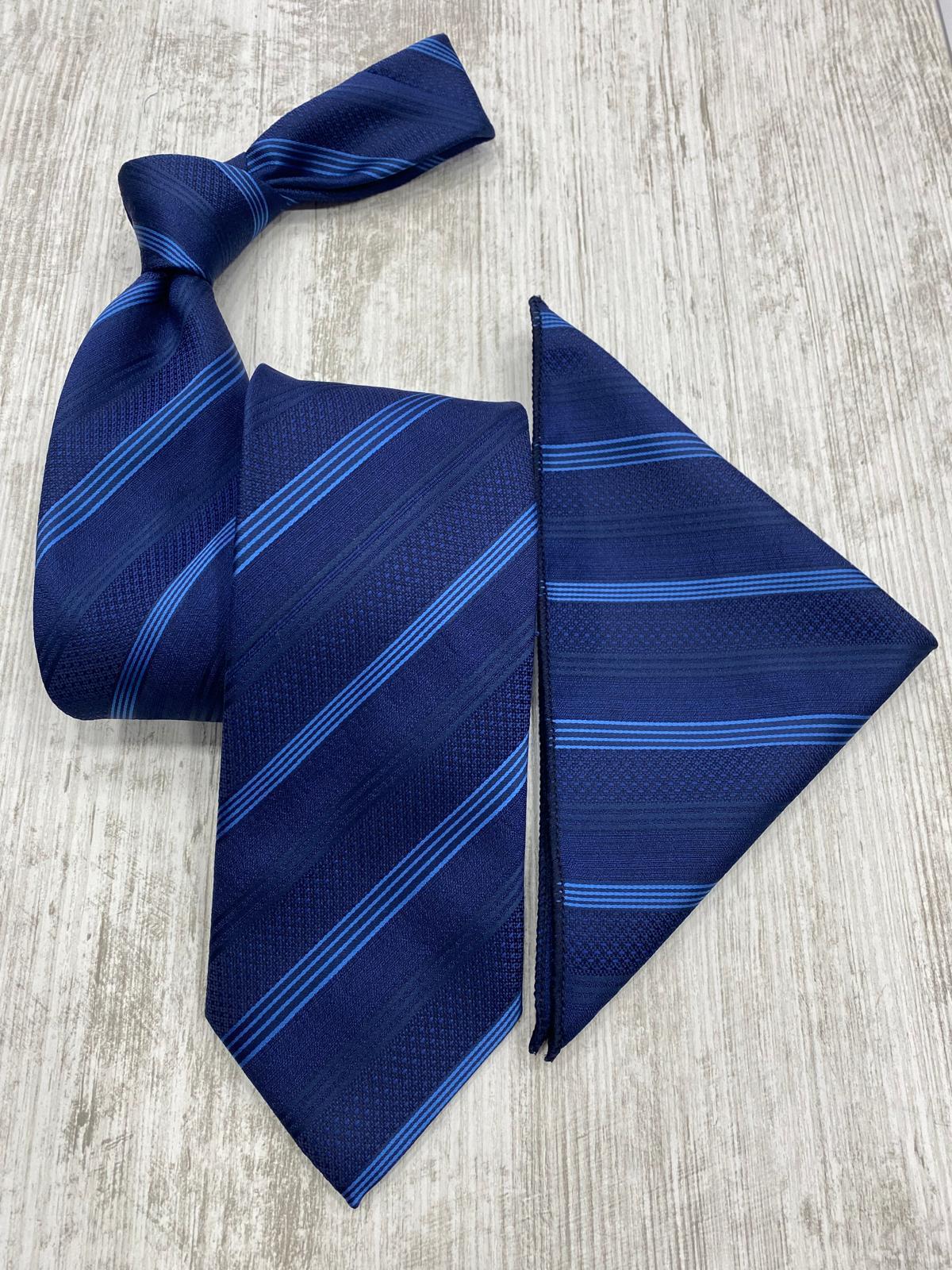 Navy blue tie and matching pocket square on a light wooden surface
