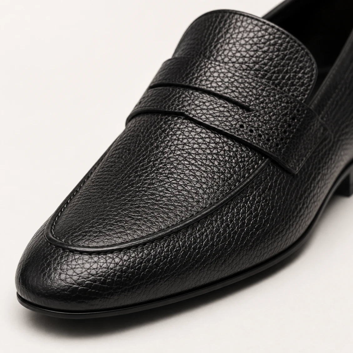 Black leather loafer shoe on a white background
