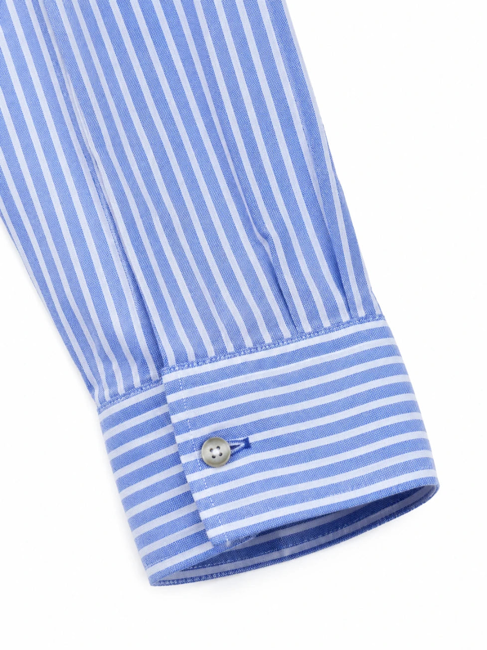 Close-up of a blue and white striped shirt cuff on a white background