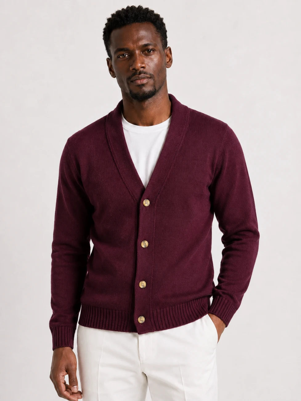 African man wearing an Infynite burgundy shawl-collar button cardigan styled for smart casual menswear.