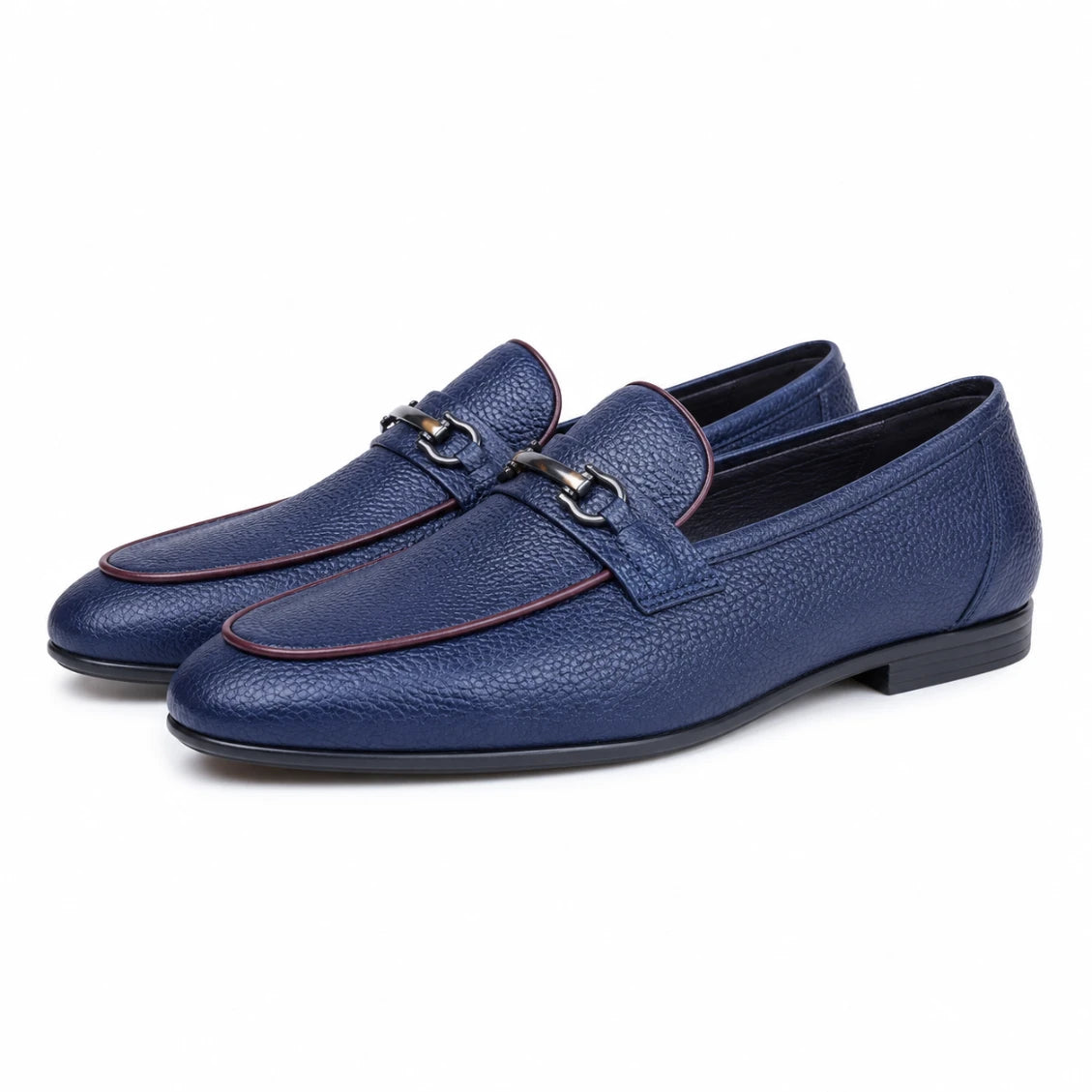 Pair of blue leather loafers on a white background